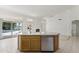Kitchen island with stainless steel dishwasher overlooking living space and outdoor pool at 19010 N 35Th Way, Phoenix, AZ 85050