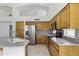 Kitchen with stainless steel appliances, granite countertops, and ample wooden cabinetry at 19010 N 35Th Way, Phoenix, AZ 85050