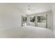 A main bedroom with neutral carpet, high ceilings, and an exterior door to the pool at 19010 N 35Th Way, Phoenix, AZ 85050