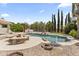 Inviting backyard pool with rock features, picnic table and mature landscaping offers a private oasis at 19010 N 35Th Way, Phoenix, AZ 85050