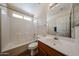 Bright bathroom featuring a single sink vanity and shower-tub combo with neutral finishes at 1920 E Westchester Dr, Chandler, AZ 85249