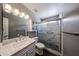 Updated bathroom featuring a glass-enclosed shower, granite vanity, and modern fixtures at 1920 E Westchester Dr, Chandler, AZ 85249