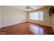Spacious bedroom with wood-look flooring, ceiling fan, and a window providing natural light at 1920 E Westchester Dr, Chandler, AZ 85249