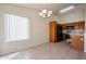 Bright dining area with tile flooring and a modern chandelier adjacent to the kitchen at 1920 E Westchester Dr, Chandler, AZ 85249