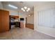 Open dining area with tile floors, modern lighting fixture, and views into the kitchen and living spaces at 1920 E Westchester Dr, Chandler, AZ 85249