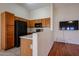 Efficient kitchen features a breakfast bar, black appliances, and stylish cabinetry at 1920 E Westchester Dr, Chandler, AZ 85249