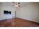 Bright and airy living room with laminate floors, ceiling fan, and neutral paint at 1920 E Westchester Dr, Chandler, AZ 85249