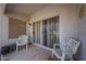 Charming covered patio area with stylish seating and sliding glass door access to the home at 1920 E Westchester Dr, Chandler, AZ 85249