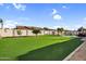 A large backyard with an artificial turf lawn and a pool and spa at 19903 E Augustus Ave, Queen Creek, AZ 85142