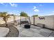 Cozy backyard patio featuring a swing, stone pavers, and a decorative palm tree at 19903 E Augustus Ave, Queen Creek, AZ 85142