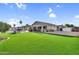 Expansive backyard featuring artificial grass, pool, and covered patio, perfect for outdoor entertainment at 19903 E Augustus Ave, Queen Creek, AZ 85142