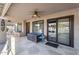 Covered patio with stone pavers, ceiling fan, storage chest and view of the pool at 19903 E Augustus Ave, Queen Creek, AZ 85142
