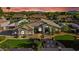 Beautiful home boasting manicured lawns, desert landscaping, and stone accents set against a picturesque sunset backdrop at 19903 E Augustus Ave, Queen Creek, AZ 85142