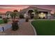 Charming single-story home with a well-manicured front yard, desert landscaping, and inviting arched entryway at 19903 E Augustus Ave, Queen Creek, AZ 85142