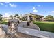 Inviting home featuring a landscaped walkway, stone accents, and well-maintained lawn for an attractive curb appeal at 19903 E Augustus Ave, Queen Creek, AZ 85142