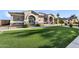 Charming home featuring lush green lawn, stone accents and beautifully landscaped walkway, making it stand out at 19903 E Augustus Ave, Queen Creek, AZ 85142