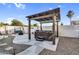 Backyard spa featuring a covered hot tub and stone pavers, perfect for relaxation at 19903 E Augustus Ave, Queen Creek, AZ 85142