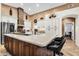 Spacious kitchen featuring a large island, modern appliances, and a stone hood over the cooktop at 19903 E Augustus Ave, Queen Creek, AZ 85142