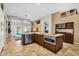 Well-lit kitchen with an island, stainless steel appliances, and a view of the outdoor living area at 19903 E Augustus Ave, Queen Creek, AZ 85142