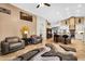Open-concept living space with cozy seating, stylish decor, and a seamless flow to the adjacent kitchen at 19903 E Augustus Ave, Queen Creek, AZ 85142