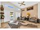 Well-lit living room with a modern design, comfortable seating, and a view to the outdoor pool area at 19903 E Augustus Ave, Queen Creek, AZ 85142