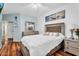 Cozy main bedroom with silver furniture, ceiling fan, hardwood floors and white duvet cover at 19903 E Augustus Ave, Queen Creek, AZ 85142