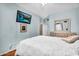 Main bedroom with ceiling fan, hardwood floors, a view of the ensuite bathroom, and white duvet cover at 19903 E Augustus Ave, Queen Creek, AZ 85142