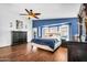 Serene main bedroom with a king-size bed, stylish furnishings, and wood-look flooring at 19903 E Augustus Ave, Queen Creek, AZ 85142