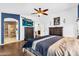 Comfortable main bedroom with a king bed, a TV, and an attached bathroom at 19903 E Augustus Ave, Queen Creek, AZ 85142