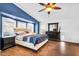 Spacious main bedroom features wood-look tile floors, a ceiling fan, and plantation shutters at 19903 E Augustus Ave, Queen Creek, AZ 85142