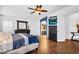 Spacious main bedroom boasts hardwood floors, ceiling fan, and an ensuite bathroom at 19903 E Augustus Ave, Queen Creek, AZ 85142