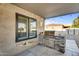 Covered outdoor kitchen with built-in grill and bar seating for entertaining outdoors at 19903 E Augustus Ave, Queen Creek, AZ 85142