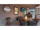 Outdoor covered patio boasts a stone bar, fire pit, outdoor TV, and ceiling fan at 19903 E Augustus Ave, Queen Creek, AZ 85142