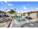 An inviting pool and spa with lounge seating, mature trees and landscaping at 19903 E Augustus Ave, Queen Creek, AZ 85142