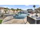 Beautiful backyard pool and spa with a stone deck, lounge chairs and mature landscaping at 19903 E Augustus Ave, Queen Creek, AZ 85142
