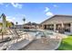 A backyard pool and spa with an artificial turf area, and a covered patio at 19903 E Augustus Ave, Queen Creek, AZ 85142
