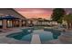 Sparkling pool and patio offer a relaxing backyard retreat with lush landscaping and comfortable seating at 19903 E Augustus Ave, Queen Creek, AZ 85142