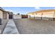 Spacious side yard with gravel and pavers, offering potential for additional parking or storage at 19903 E Augustus Ave, Queen Creek, AZ 85142