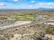 Breathtaking aerial view showcasing the community, golf course, and highway, blending urban and natural landscapes at 20453 W Daniel Pl, Buckeye, AZ 85396