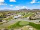 Scenic aerial view of the golf course, lake, and surrounding desert landscape, creating a serene backdrop at 20453 W Daniel Pl, Buckeye, AZ 85396