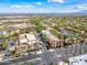 High-angle view displaying the neighborhood's architectural style, palm-lined streets, and commercial spaces at 20453 W Daniel Pl, Buckeye, AZ 85396
