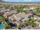 Aerial view showcases a property with a private pool, covered patio, and meticulously landscaped backyard at 20453 W Daniel Pl, Buckeye, AZ 85396