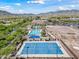 Wide aerial view of the recreation center including the pools, basketball court, and lush landscaping at 20453 W Daniel Pl, Buckeye, AZ 85396
