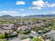 Scenic aerial view of a residential area showcasing many homes with lush greenery and mountain views at 20453 W Daniel Pl, Buckeye, AZ 85396