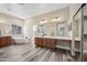 Elegant bathroom with modern fixtures, dual sinks, and a luxurious soaking tub at 20453 W Daniel Pl, Buckeye, AZ 85396