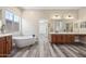 Spacious bathroom featuring a freestanding tub and double sink vanity at 20453 W Daniel Pl, Buckeye, AZ 85396