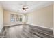 Bright bedroom with large windows and wood-look floors, flooded with natural light at 20453 W Daniel Pl, Buckeye, AZ 85396