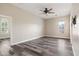 Bright bedroom features a ceiling fan and window with plantation shutters for ample natural light at 20453 W Daniel Pl, Buckeye, AZ 85396