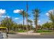 Scenic view of the community featuring mature trees, landscaped grounds, and an American flag at 20453 W Daniel Pl, Buckeye, AZ 85396