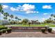Entrance to community swim park with palm trees and manicured landscaping, offering a Gathering-friendly environment at 20453 W Daniel Pl, Buckeye, AZ 85396